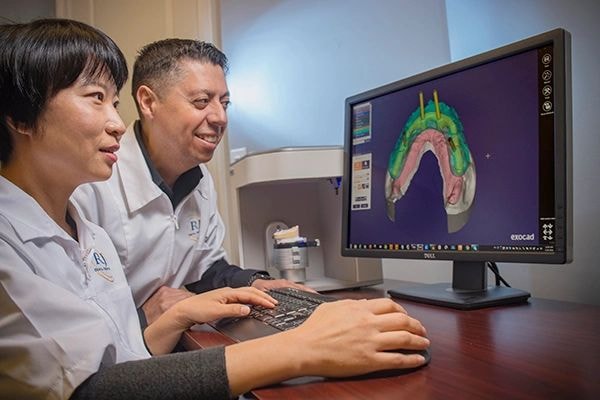 Dental prosthetics being carefully crafted in a lab